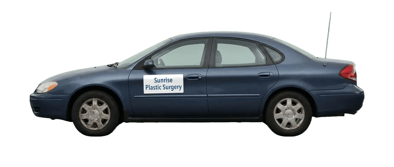 An older blue sedan with a magnetic practice sign on the door, the visual shorthand for marketing that's fine but isn't winning anymore